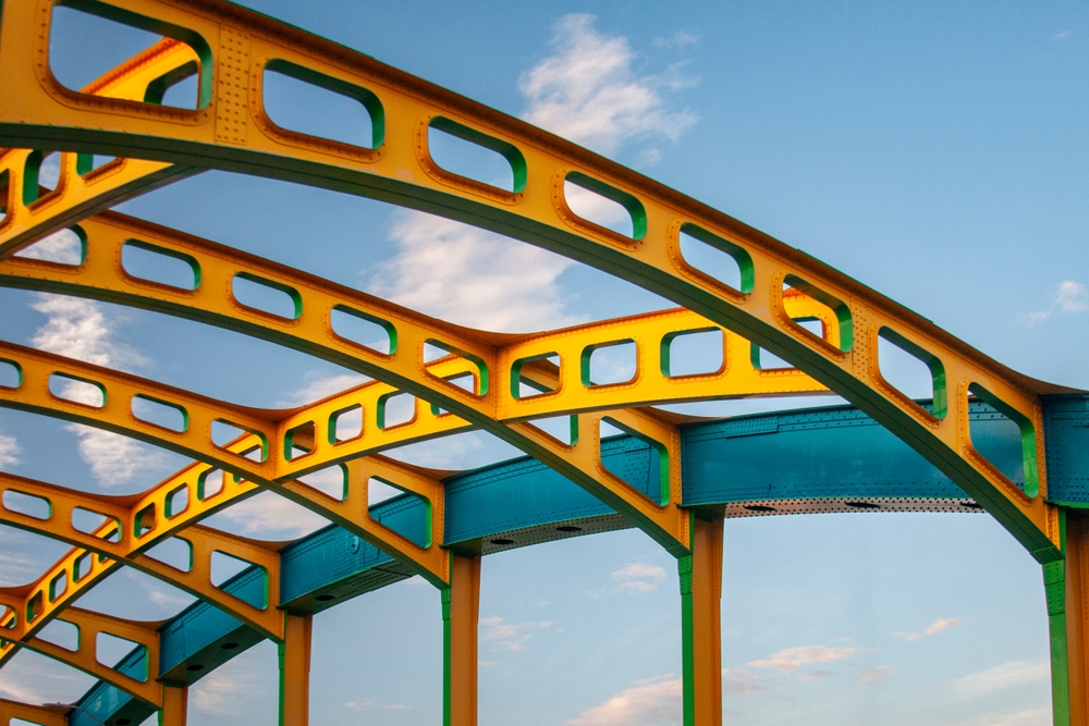 A yellow and blue steel bridge, in this context representing the crossover between SEO and UX